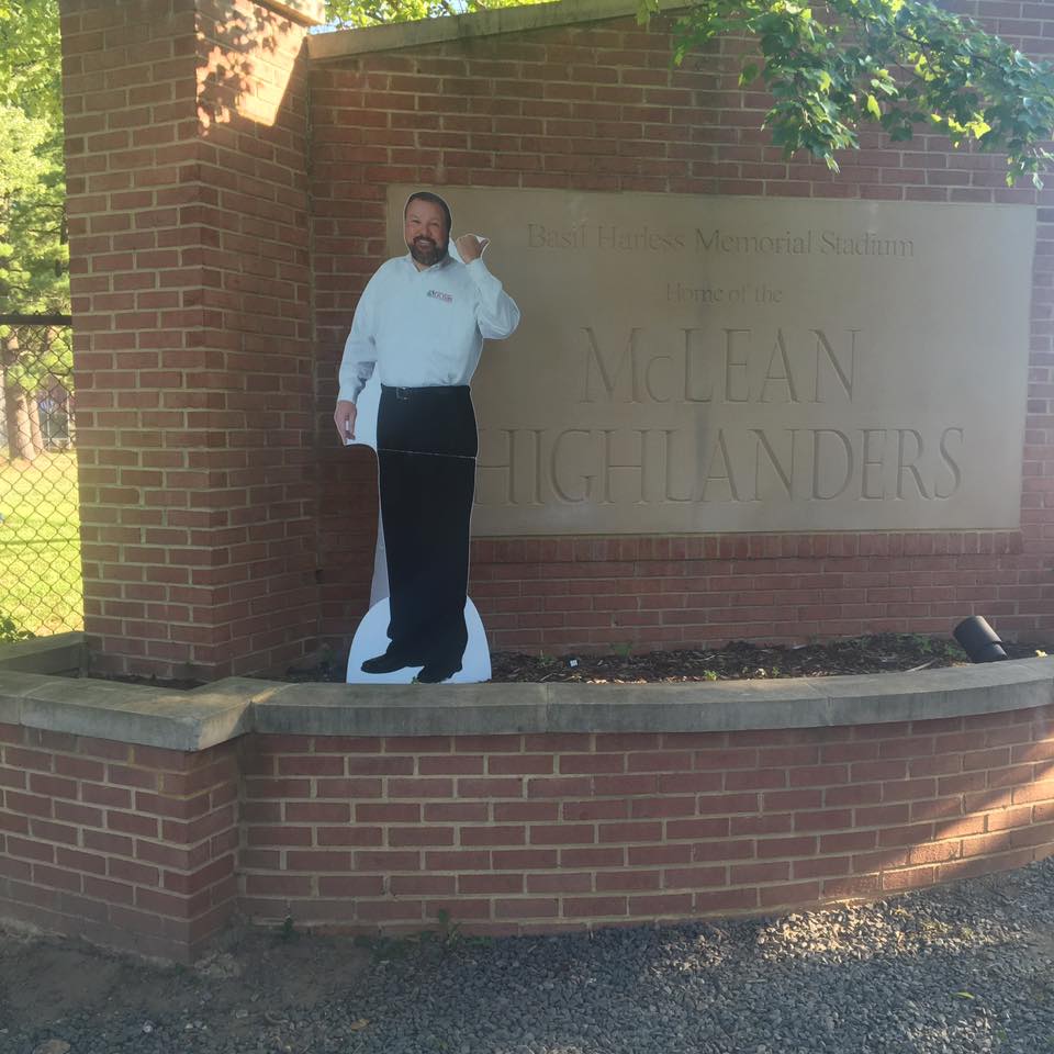 Mr. Furr cardboard cutout in front of McLean Highlanders brick school sign.
