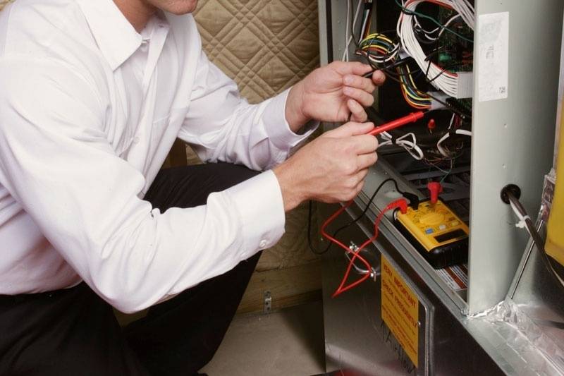 Technician repairing a furnace.